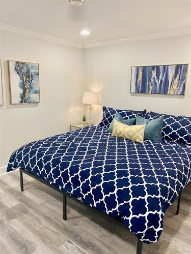 a bedroom with a bed with a blue and white comforter at 8th Floor Stylish Downtown Condo Private Balcony in Atlanta