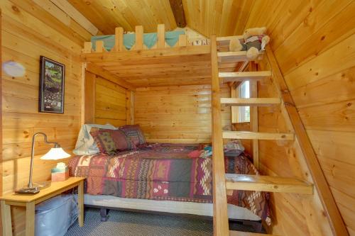 a log cabin bedroom with a bunk bed and a ladder at Ultimate Alaskan Retreat Lakefront Soldotna Cabin in Ridgeway