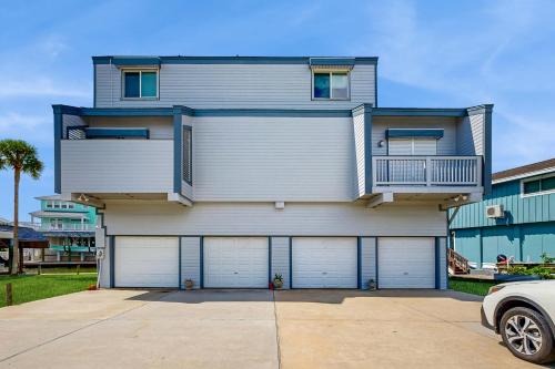 a house with four garage doors in front of it at Tiki Hideaway in Village of Tiki Island