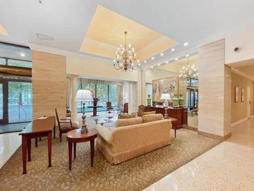 a large living room with a couch and a table at 8th Floor Stylish Downtown Condo Private Balcony in Atlanta