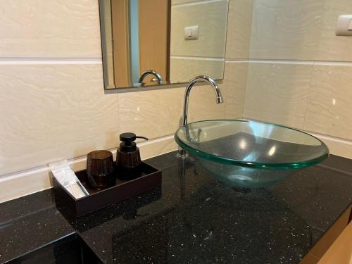 a glass bowl sink on a counter in a bathroom at Royal Kamala - 1 separated bedroom Condo in Kamala Beach