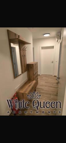 a bathroom with a vanity and a mirror on the wall at White Quenn Apartments in Sanski most