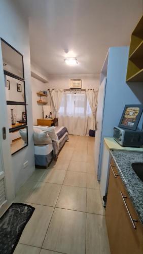 a room with a room with two beds in it at Laidback Cavern at Studio City Alabang in Manila