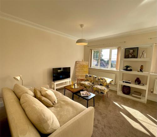 a living room with a couch and a tv at Clevedon House in Newport