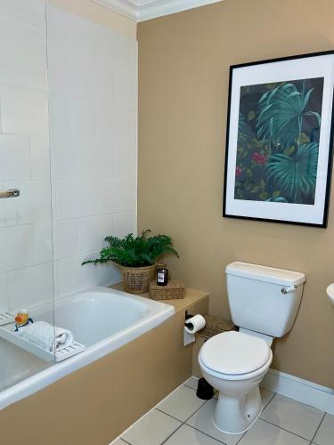 a bathroom with a tub and a toilet and a sink at Clevedon House in Newport