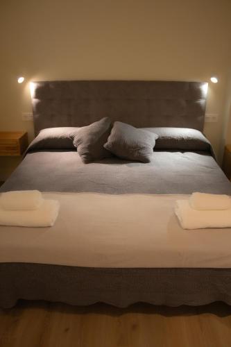 a large bed with two pillows on top of it at Luminoso Bilbao in Bilbao