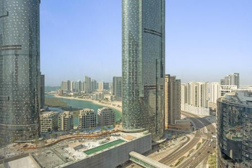 a view of a city with tall buildings at Desert Key - Platinum Apartments in Gate Tower, Al Reem Island in Abu Dhabi