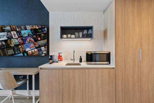 une cuisine avec un évier et un micro-ondes sur un comptoir dans l'établissement Downtown Luxury Stay with Complimentary Parking, à Miami