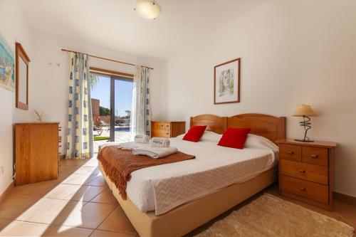 a bedroom with a large bed with red pillows at B36 - Dona Ana Secluded Spot in Lagos