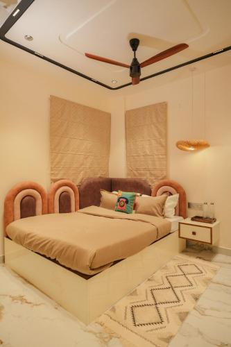 a bedroom with a bed and a ceiling fan at The Nomads Escape in Siliguri