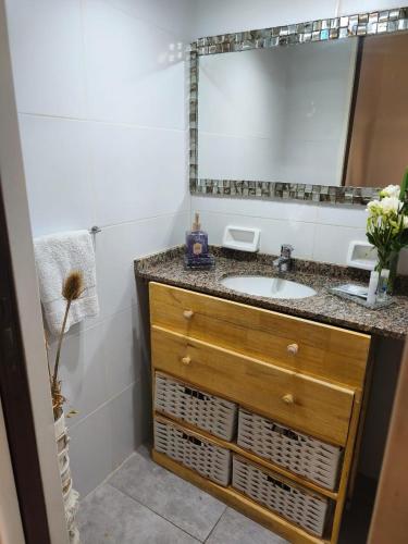 a bathroom with a sink and a mirror at YouHouse Paraná in Buenos Aires