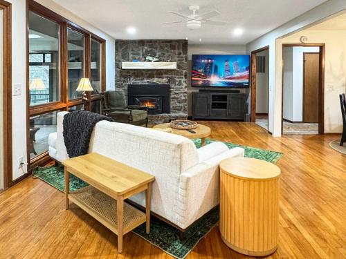 a living room with a couch and a tv at Riverfront Retreat - Right next to the White River in Norfork