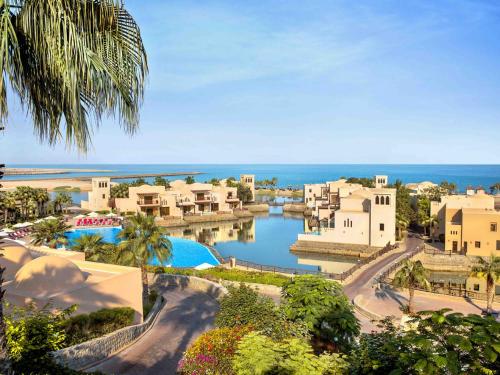 a view of a resort with a body of water at Exclusive 2BR Poolside Villa 5 Star Resort Escape in Ras al Khaimah