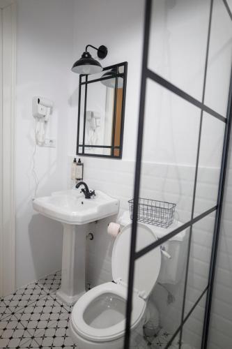 a bathroom with a white toilet and a sink at Citadelle house in Alba Iulia