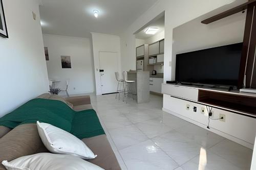 a large living room with a large flat screen tv at Apartamento em Pomerode Centro - Térreo in Pomerode