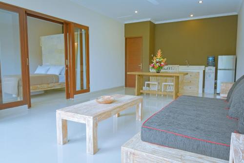 a living room with a bed and a table at Villa Padma Ubud in Ubud