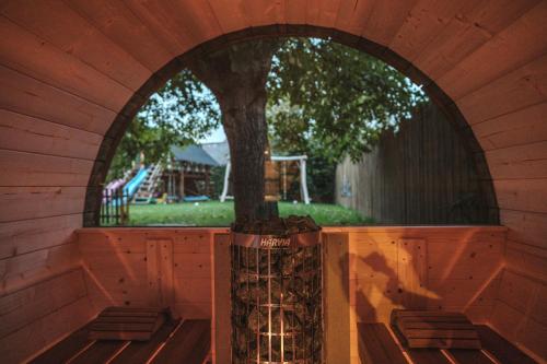 a tree in a tree house with an archway at Apartmán V medvědím brlohu in Dolní Lomná