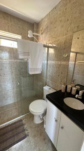 a bathroom with a toilet and a sink and a shower at Elaine Graziela in Pitimbu
