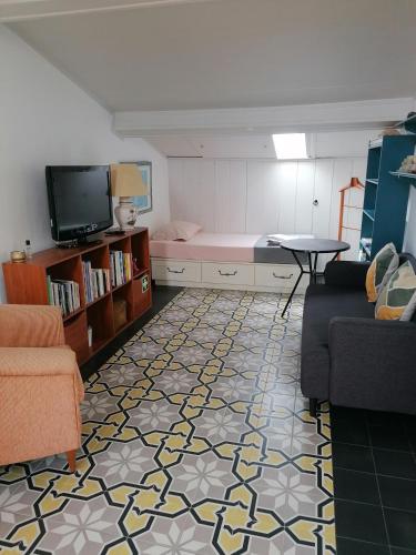 a living room with a couch and a table at Varandas Miramar in Angra do Heroísmo