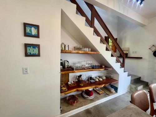 a staircase with wooden shelves in a living room at Casa Amor With Sea View in Goiana