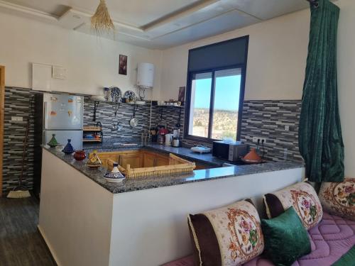 a kitchen with a large island in a room at Reda House in Ikouzza