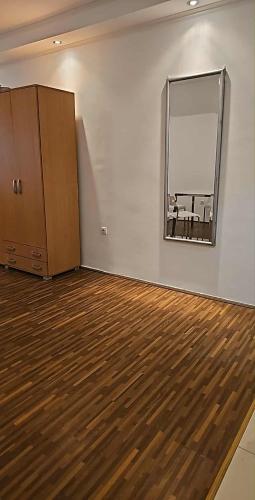 a room with a mirror and a wooden floor at Swiss Luxury Apartment in Beograd