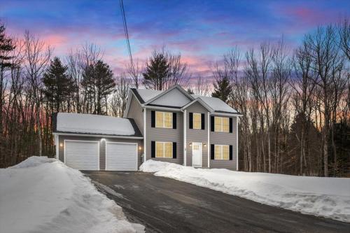 a house on a street in the snow at Private Primary Suite in New 2024 Home, Ashburnham with Parking and Wi-Fi in Ashburnham