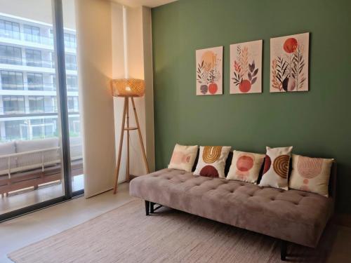 a living room with a couch with pillows on it at Minimalist 1BR Amazing View in Morros Eos in Cartagena de Indias