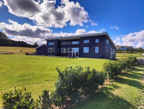 a large house in a field with a grassy yard at 6844-Allinge-Aeblebakken-8 in Allinge