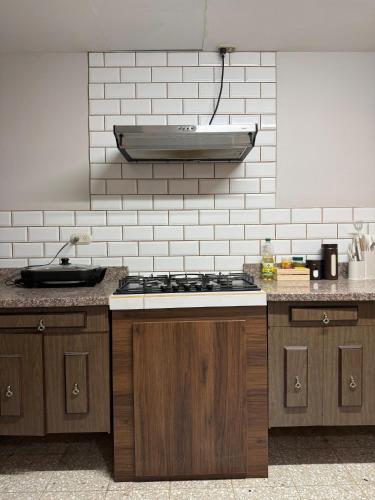 a kitchen with a sink and a stove top at Harmony Hotel by Haven in San José