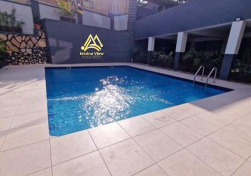 a swimming pool in the middle of a building at Marina View Luxury Suites Munyonyo Kampala in Kampala