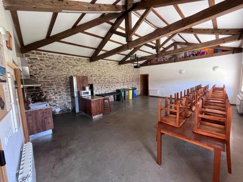 a room with a row of chairs in a building at Alojamiento Rural La Arboleda in Noviercas