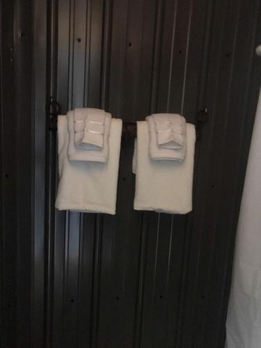 two white towels are hanging on a wall at A Truly Glamping Experience in this Beautiful Tent in Victor, West Virginia in Victor