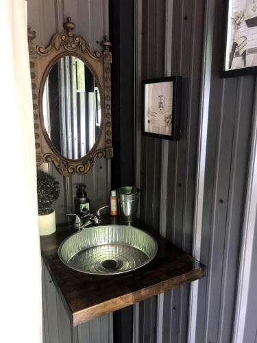 a bathroom with a sink and a mirror at A Truly Glamping Experience in this Beautiful Tent in Victor, West Virginia in Victor