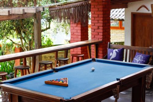 a pool table sitting on a deck with at Pousada Green in Florianópolis