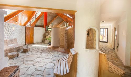 a large room with a stone floor and wooden ceilings at Romantik Hotel Stryckhaus in Willingen