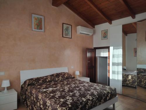 a bedroom with a bed in a room at La Coccinella in Canale Monterano