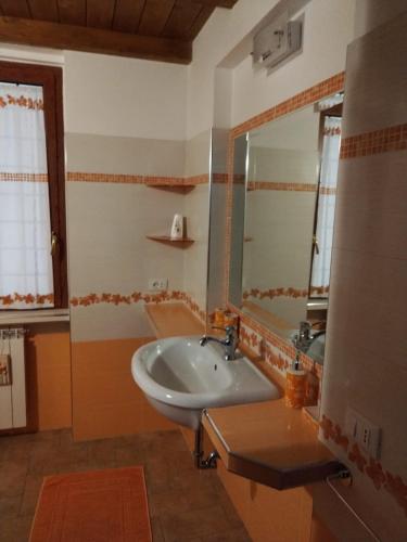 a bathroom with a sink and a mirror at La Coccinella in Canale Monterano