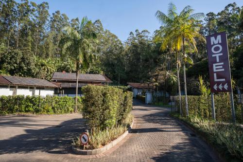 a sign for a motel next to a road at MOTEL 3 PEIXINHOS (Adults Only) in Blumenau