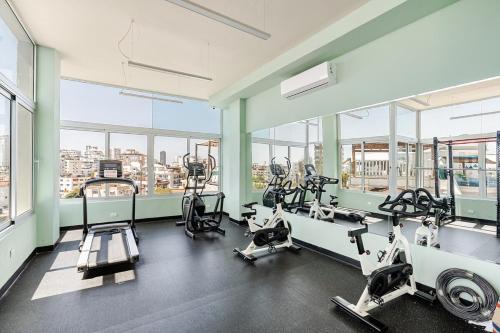 a gym with treadmills and machines in a building at Cozy Apartment near Downtown Center in Santo Domingo