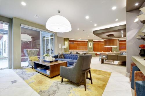 a living room with a blue couch and a table at One Bedroom Downtown Luxury Apartment - Fast Wi-Fi - Free Parking in San Antonio