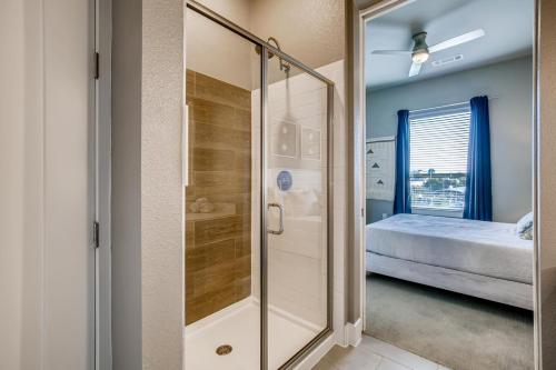a glass shower in a bedroom with a bed at One Bedroom Downtown Luxury Apartment - Fast Wi-Fi - Free Parking in San Antonio