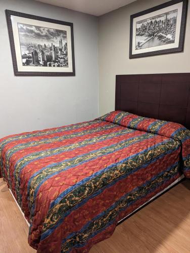 a bedroom with a bed with a colorful comforter at Executive Inn Coopersburg in Coopersburg