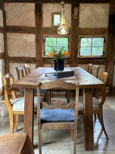 a dining room with a wooden table and chairs at Ickelhaus 2 in Bad Windsheim