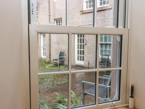 a window with a view of a courtyard at 2 East Port in Melrose