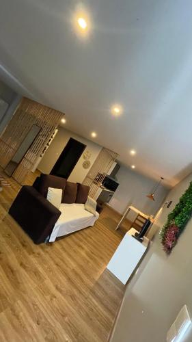 a living room with a white couch and a wooden floor at Porto Rio Douro apart in Valbom