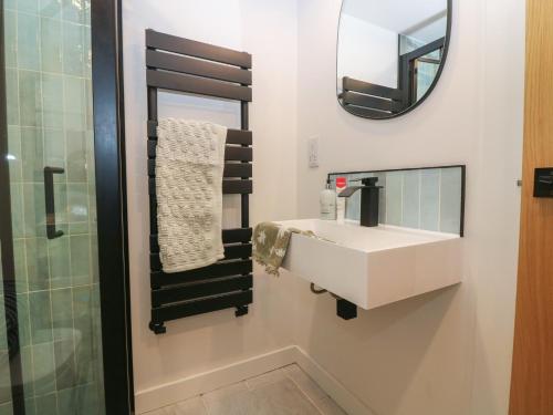 a bathroom with a sink and a mirror at 2 East Port in Melrose