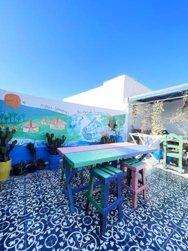 a ping pong table in front of a mural at Hostel Hotel & Riad in Essaouira