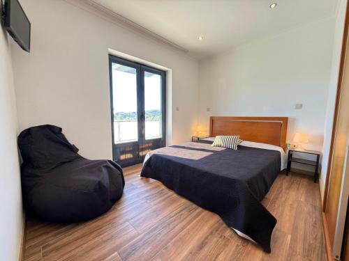 En eller flere senge i et værelse på Casa Fouces - Piscina - Gerês