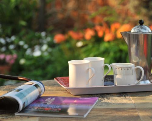 a table with three coffee mugs on a tray at Claires of Sandton Luxury Guest House in Johannesburg